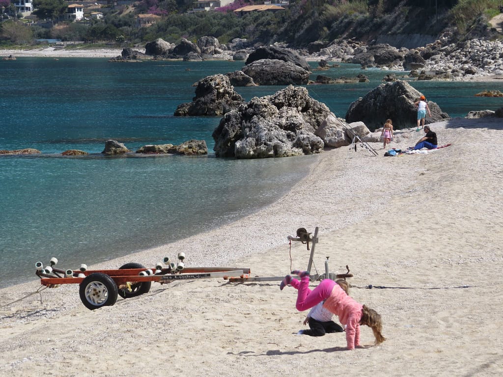 La spiaggia di Agios Nikitas, con la sua sabbia dorata e acque poco profonde, è perfetta per le famiglie. Bambini che giocano e si divertono mentre i genitori possono rilassarsi in un'atmosfera serena e sicura.