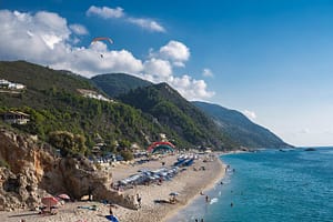 La spiaggia di Kathisma, in estate, diventa una pista di atterraggio per i parapendio, offrendo uno spettacolo emozionante per i visitatori.